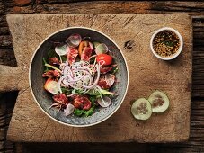 Thai salad with fried beef, tomatoes and broccoli