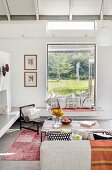 Masonry window seat with view of garden in bright, comfortable living area