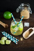 Virgin Caipirinha Cocktail made form ginger ale, limes and brown sugar with straws