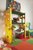 DIY shelving in child's bedroom - shelves covered in artificial grass, side walls with climbing holes