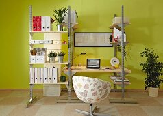 DIY shelving system with integrated desk made from metal rails and wooden panels in study