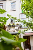 Contemporary balcony added to renovated period-building façade in sunny garden