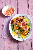 Persimmon salad with prosciutto, pumpkin seeds and pomegranate