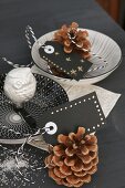 Decorative china bowls, silver owl and pine cones
