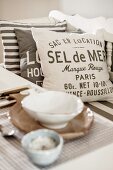 Printed cushions and place setting in blurred foreground