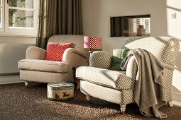 Traditional armchairs with beige covers next to window