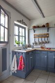 Country-style kitchen counter with blue-grey base units