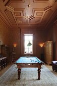 Games room with carved, wood-panelled ceiling