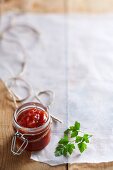 Tomato relish in a flip-top jar on a piece of paper