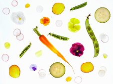 Slices of back-lit vegetables and edible flowers
