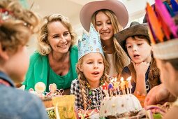 A multi-generational family celebrating a child's birthday