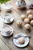 Teatime in a garden with tea and scones on a wooden table