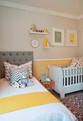 Scatter cushions and teddy on bed and cot in nursery