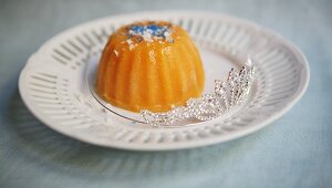 Pumpkin pudding with blue sugar sprinkles and a tiara