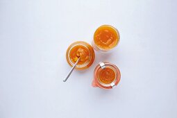 Jars of pumpkin and apricot jam with nutmeg flowers