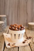 An arrangement of hazelnuts in a wooden basket