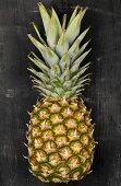A pineapple on a black surface