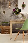 Ornamental cabbage in glass vase on vintage table, plants growing in suspended glass spheres and pale green, classic shell chair