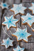 Gingerbread star biscuits decorated with blue and white icing