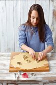 A little girl cutting out biscuits