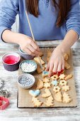 A girl decorating homemade Christmas biscuits
