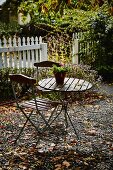 Small table and chairs in autumnal garden