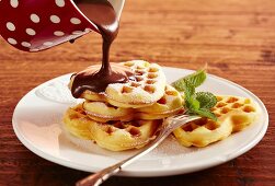 Heart-shaped waffles with rum and chocolate sauce