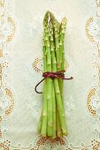 A bundle of green asparagus on a tablecloth
