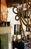 Detail of candle chandelier decorated with wooden beads and glass lanterns in vintage interior