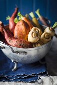 Parsnips, sweet potatoes and carrots in a colander