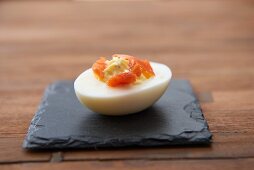 A devilled egg with smoked salmon