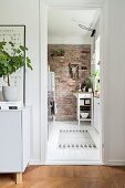 View into kitchen with brick wall