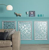 Elegant wall design: moulded dado rail and panelling hand-made from patterned wallpaper and moulding strips