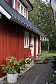 Falu-red Swedish house with terrace in summer garden