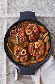 Osso buco with vegetables in a braising dish