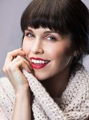 Dark-haired woman wearing white knitted sweater