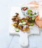 Tandoori chicken skewers with yoghurt sauce and pickled cucumber