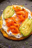 Coconut flour pizza with goat's cheese, avocado and smoked salmon