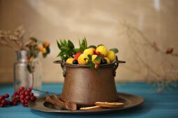 Various winter fruit in a metal pot