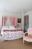 Four-poster bed decorated with red and white fabrics