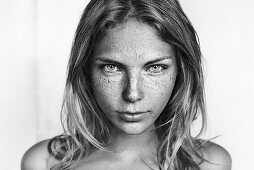 A young blonde woman with lots of freckles (black-and-white shot)