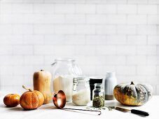 Still life with different kinds of pumpkin and ingredients for pumpkin dishes