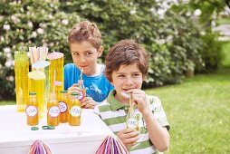Two boys with bottles of drink at a birthday party