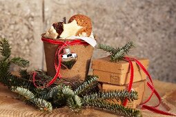 Terracotta pot covered in cardboard used as festive biscuit container