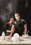 A messy young couple baking cake