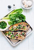 Baked aubergines with garlic, cheese, parsley and raisins