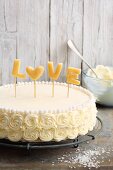 A marzipan buttercream cake decorated with the word 'Love'