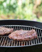 Beef steaks on barbecue