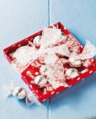 Chocolate pralines in silver foil as a gift