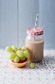 A banana and chia smoothie with grapes and grapefruit